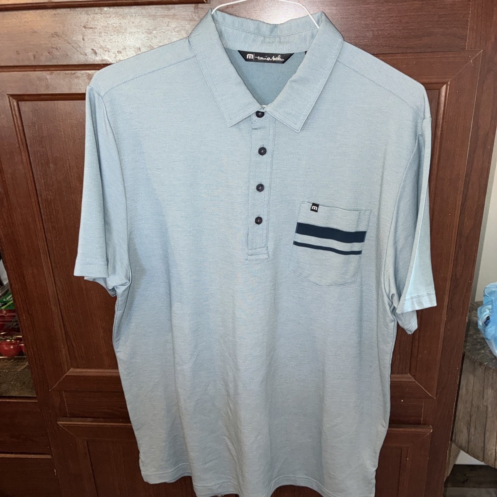 travis matthew lg polo blue short sleeve 4 button front pocket